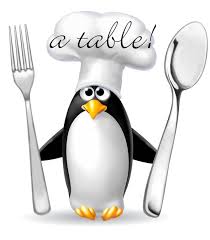 Photo de pingouin déguisé en chef de cuisine avec une fourchette et une cuillère dans les mains avec écrit à table